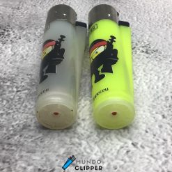 Two gray and yellow Clipper lighters with ninja stick figures made in Spain.