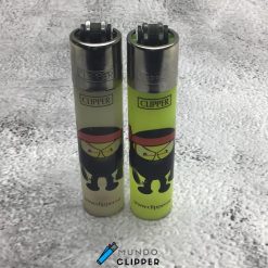 Two gray and yellow Clipper lighters with ninja stick figures made in Spain.